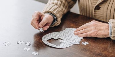 Cropped view of senior man playing with puzzles