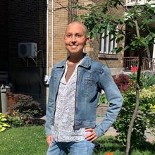 Nadia Chaudhri stands in front of a building at Concordia University.